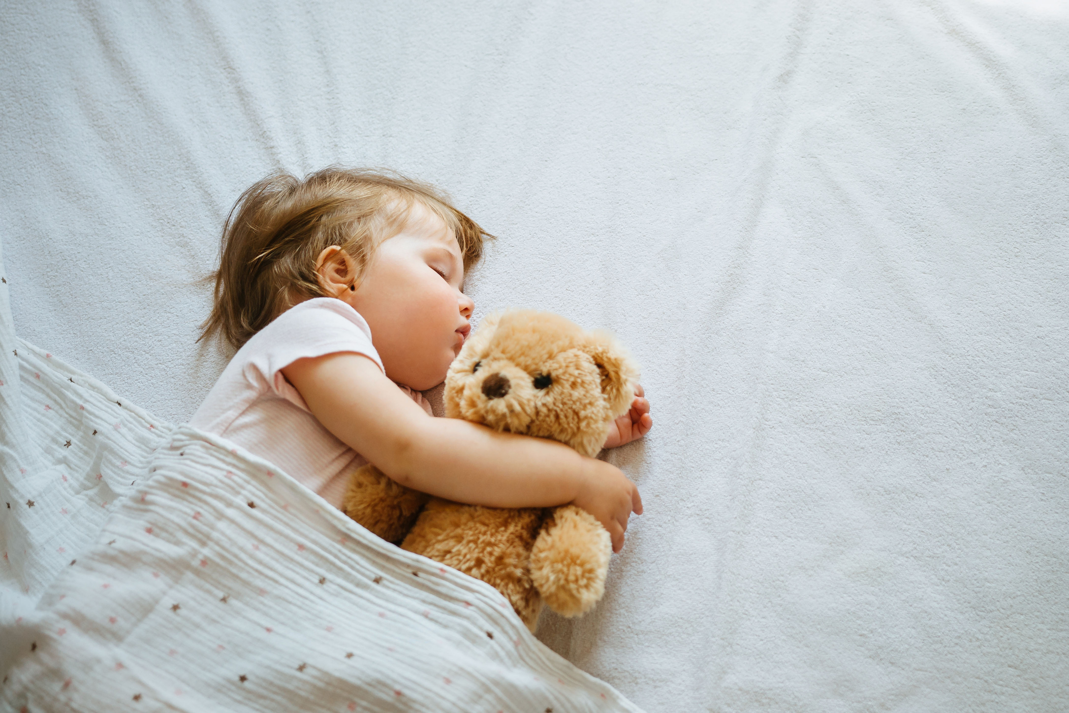 Sleeping Baby Hugging a Teddy Bear